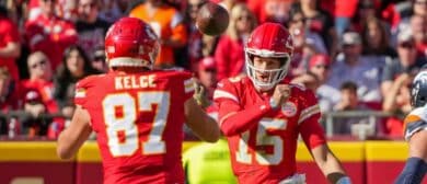 Kansas City Chiefs quarterback Patrick Mahomes (15) throws to tight end Travis Kelce (87) against the Denver Broncos during the first half at GEHA Field at Arrowhead Stadium.