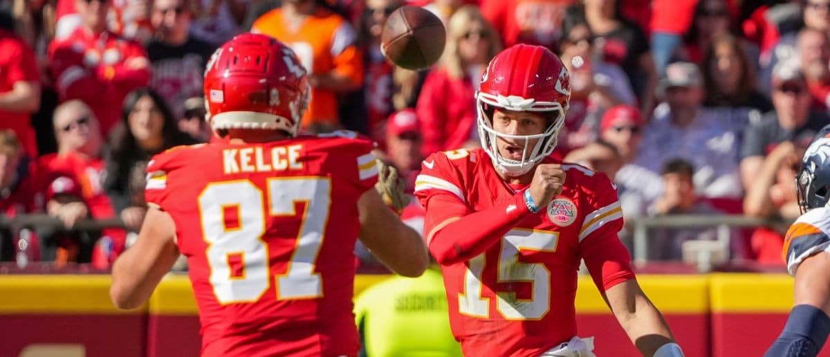 Kansas City Chiefs quarterback Patrick Mahomes (15) throws to tight end Travis Kelce (87) against the Denver Broncos during the first half at GEHA Field at Arrowhead Stadium.