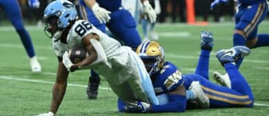 Winnipeg Blue Bombers defensive end Celestin Haba (45) tackles Toronto Argonauts wide receiver Damonte Coxie (86) at BC Place