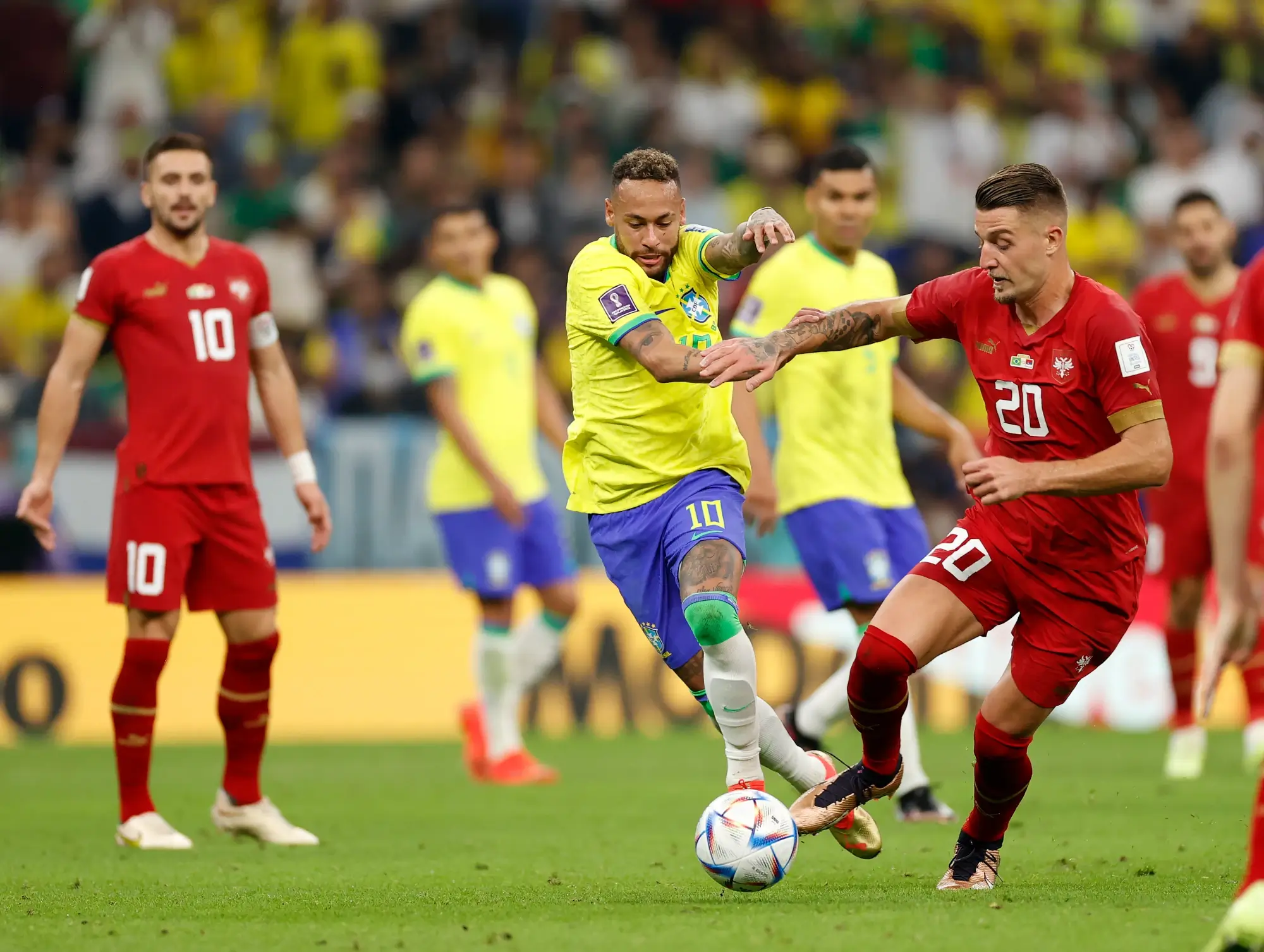 Nov 24, 2022; Lusail, Qatar; Brazil forward Neymar (10) kicks the ball past Serbia midfielder Sergej Milinkovic-Savic (20) during the second half in a group stage match during the 2022 World Cup at Lusail Stadium.