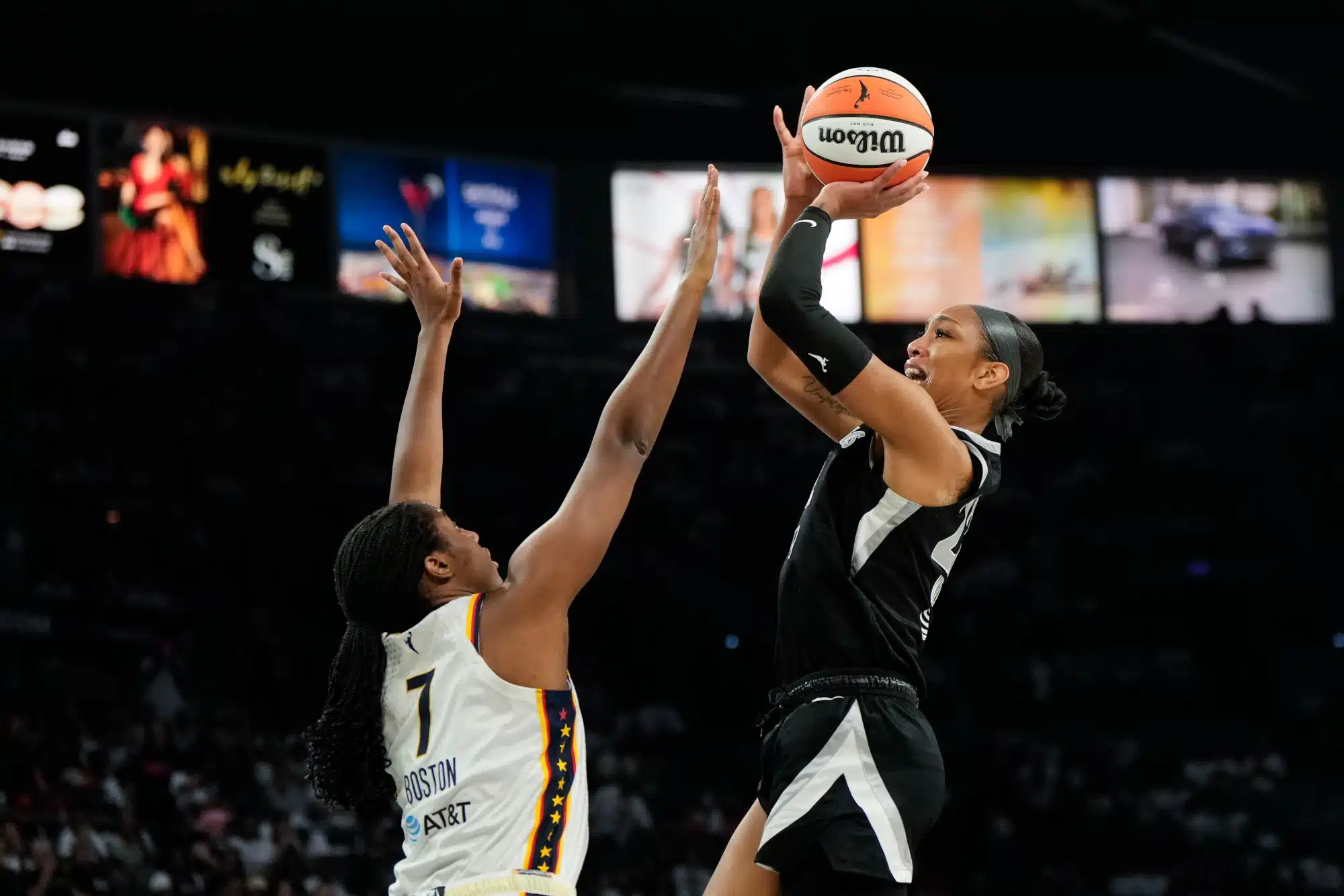 Sep 21, 2025; Las Vegas, Nevada, USA; Las Vegas Aces center A'ja Wilson (22) shoots the ball against Indiana Fever center Aliyah Boston (7) during the third quarter in game one of the second round for the 2025 WNBA Playoffs at Michelob Ultra Arena.