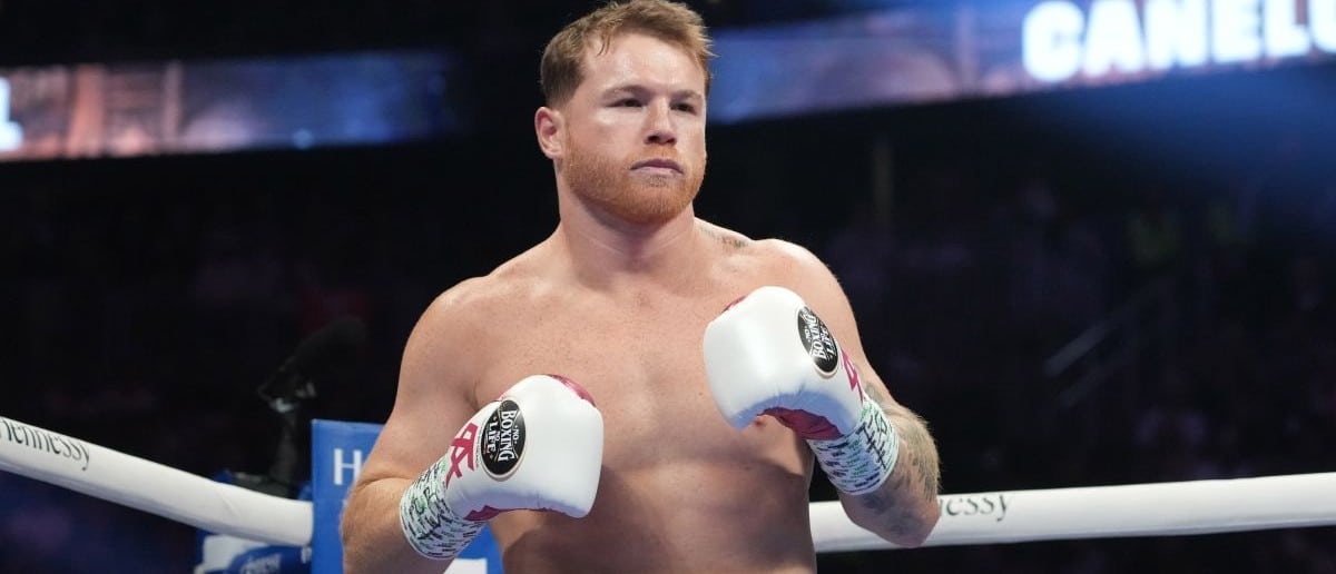 Canelo Alvarez (pink trunks) and Dimitry Bivol (black trunks) box during their light heavyweight championship bout at T-Mobile Arena