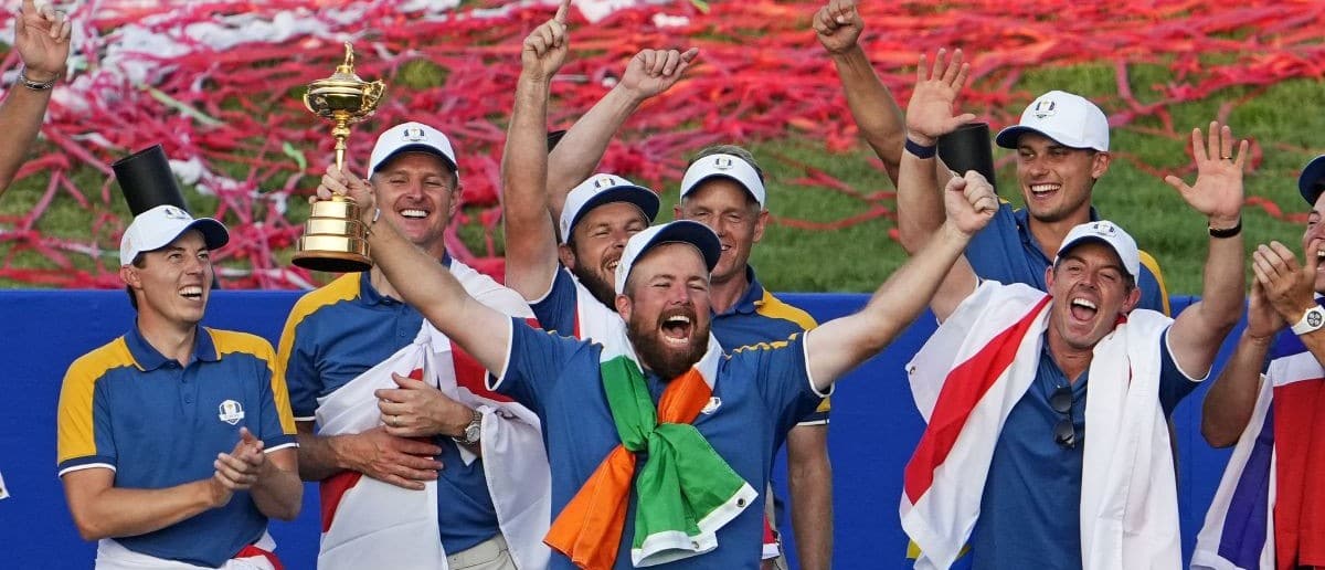 Team Europe golfer Shane Lowry and Team Europe celebrates with the Ryder Cup trophy after beating Team USA during the final day of the 44th Ryder Cup golf competition at Marco Simone Golf and Country Club.