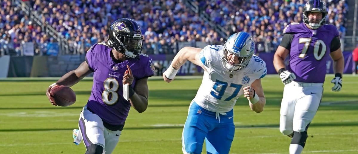 Baltimore Ravens quarterback Lamar Jackson (8) is pressured by Detroit Lions defensive lineman Aidan Hutchinson (97) during the fourth quarter at M&T Bank Stadium