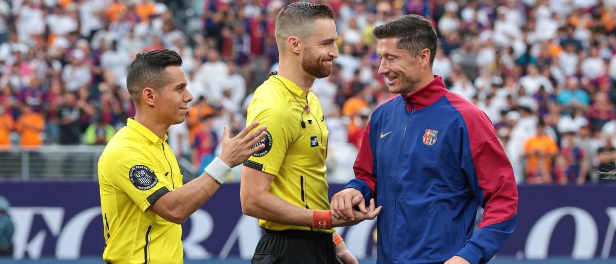 Barcelona forward Robert Lewandowski (9) shakes hands with officials before an international friendly against Real Madrid at MetLife Stadium.
