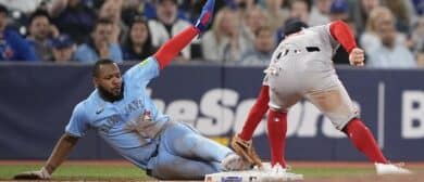 Toronto Blue Jays first baseman Vladimir Guerrero (27) slides in safe to third base against Boston Red Sox third baseman Alex Bregman (2) during the tenth inning at Rogers Centre