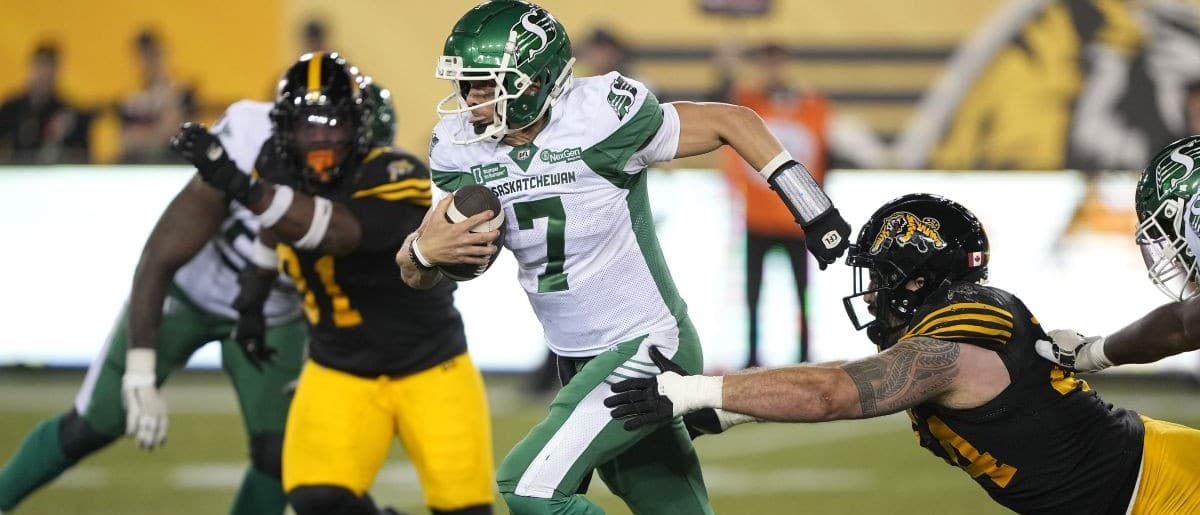 Saskatchewan Roughriders quarterback Trevor Harris (7) breaks a tackle from Hamilton Tiger-Cats defensive lineman Casey Sayles (44) during the second half at Hamilton Stadium.