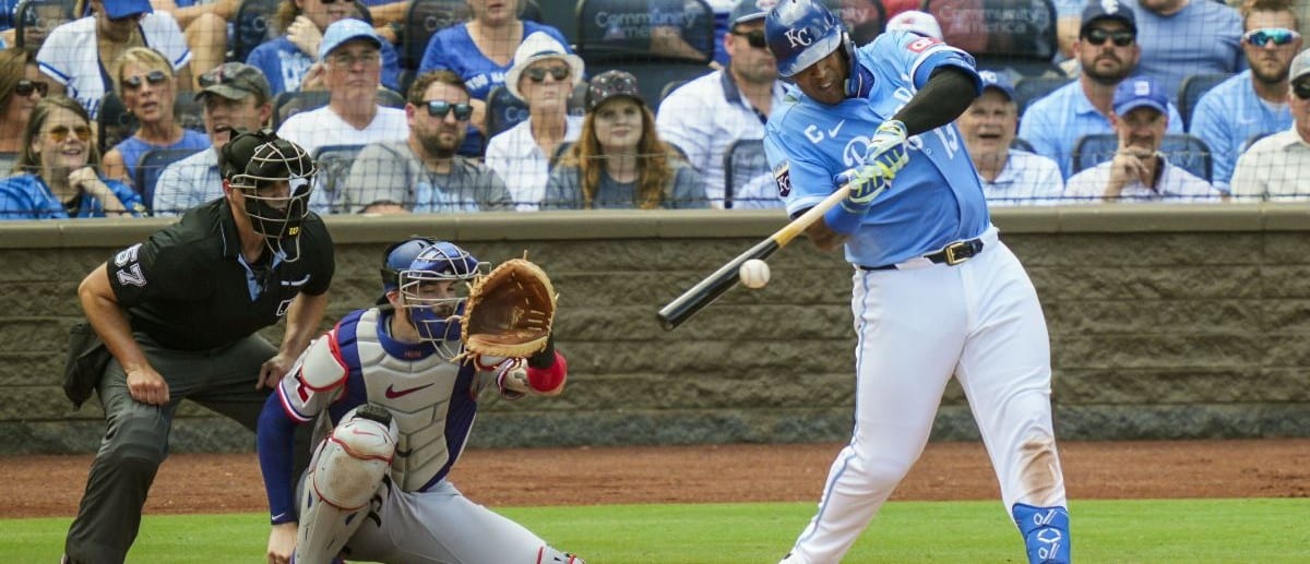 Kansas City Royals designated hitter Salvador Perez (13) hits an RBI single during the third inning against the Texas Rangers at Kauffman Stadium