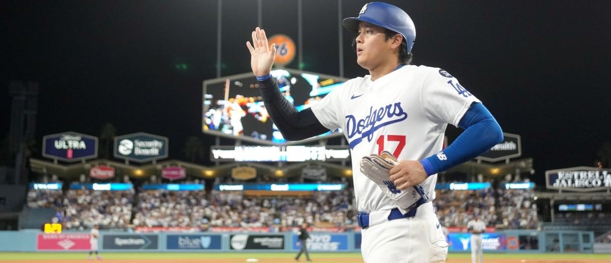 Los Angeles Dodgers designated hitter Shohei Ohtani (17) returns to the dugout after scoring in the seventh inning against the Colorado Rockies at Dodger Stadium