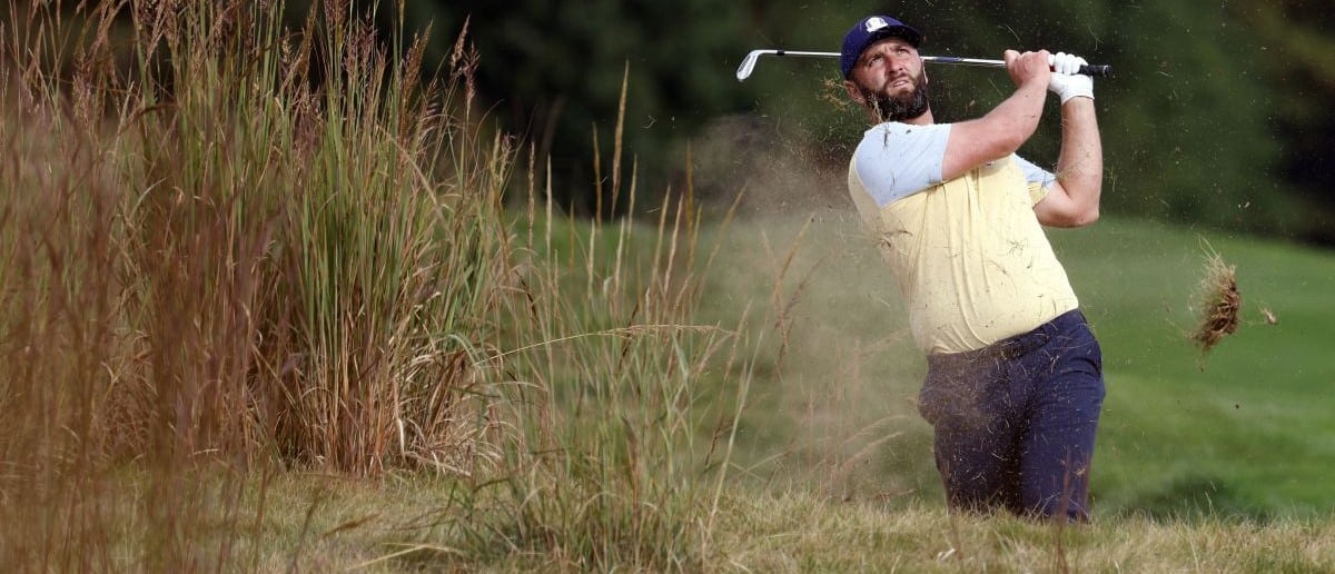 Jon Rahm plays from the rough on the 11th hole during a practice round of the Ryder Cup golf tournament at Bethpage Black.