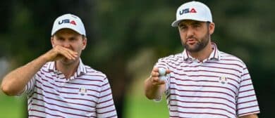 Scottie Scheffler and Russell Henley talk about the greens on the first hole during a practice round of the Ryder Cup golf tournament at Bethpage Black.