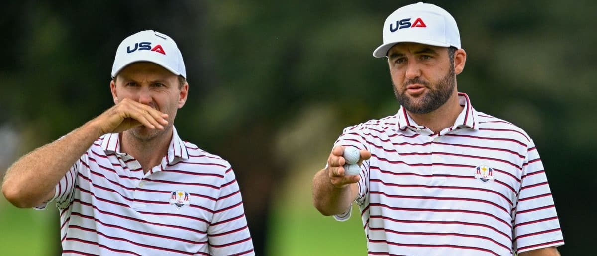 Scottie Scheffler and Russell Henley talk about the greens on the first hole during a practice round of the Ryder Cup golf tournament at Bethpage Black.