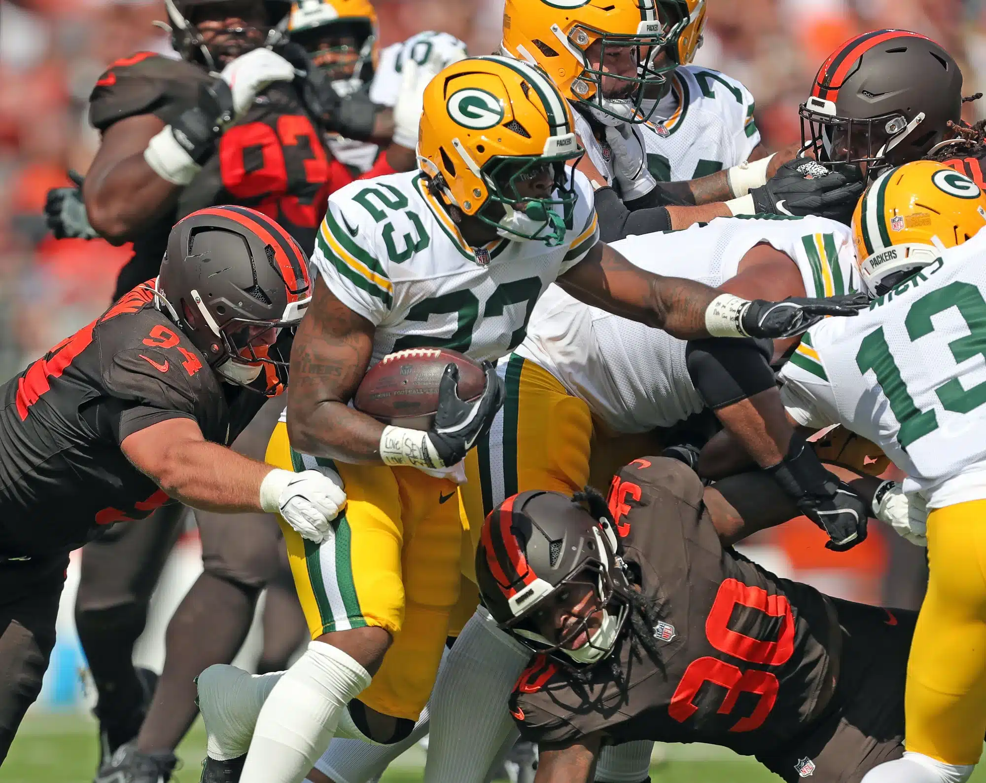 Cleveland Browns defensive tackle Mason Graham (94) and linebacker Devin Bush (30) make an effort to bring down Green Bay Packers running back Emanuel Wilson (23) during the first half of an NFL football game at Huntington Bank Field, Sept. 21, 2025, in Cleveland, Ohio.