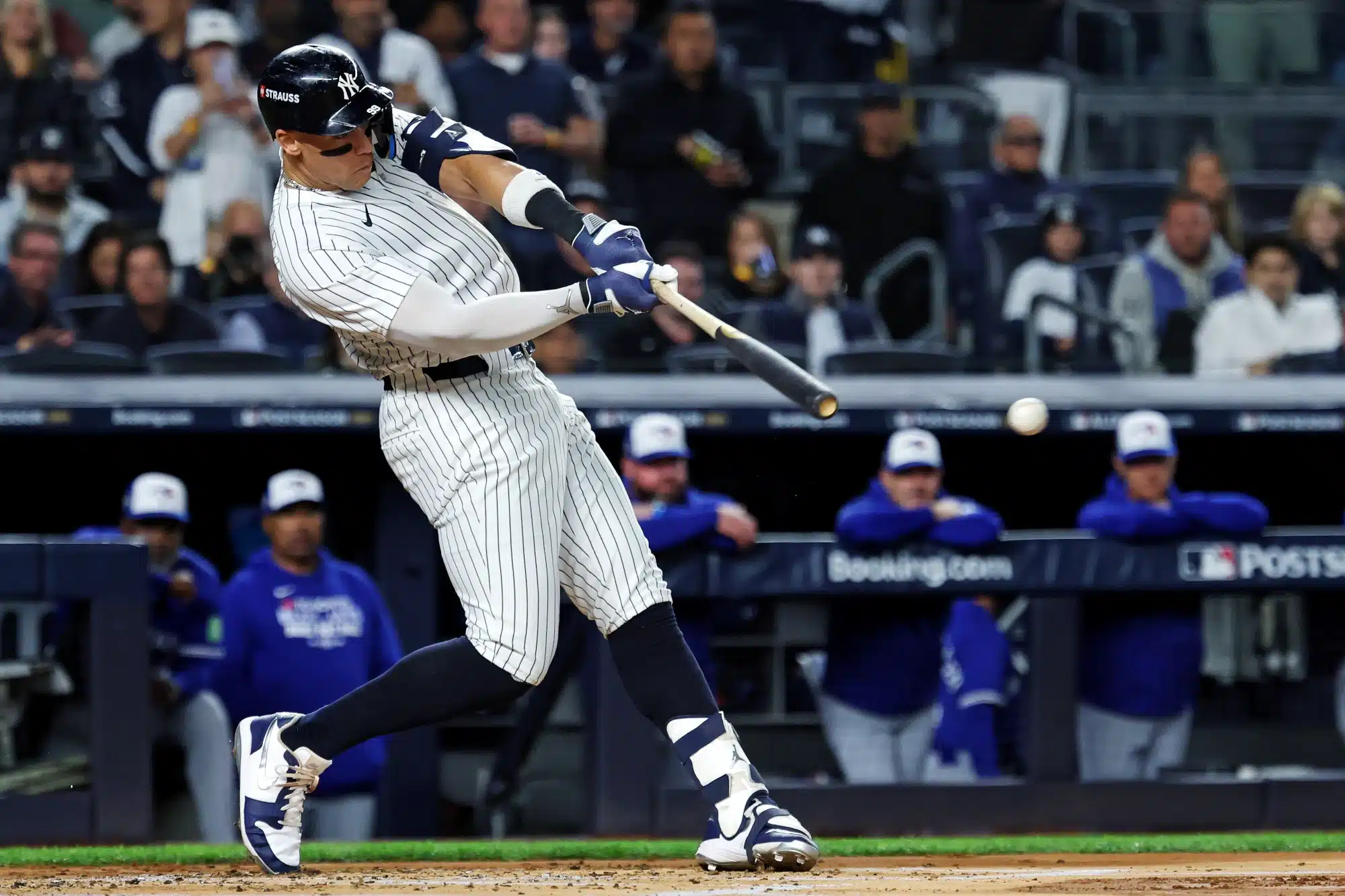 Oct 8, 2025; Bronx, New York, USA; New York Yankees right fielder Aaron Judge (99) hits a single during the first inning against the Toronto Blue Jays during game four of the ALDS round for the 2025 MLB playoffs at Yankee Stadium.