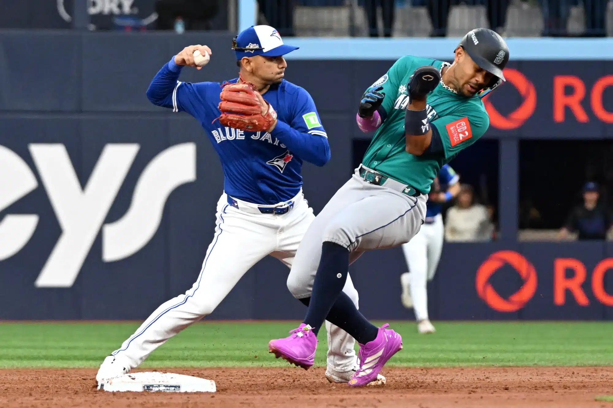 Oct 13, 2025; Toronto, Ontario, CAN; Toronto Blue Jays second baseman Andres Gimenez (0) forces out Seattle Mariners center fielder Julio Rodriguez (44) in the third inning during game two of the ALCS round for the 2025 MLB playoffs at Rogers Centre.