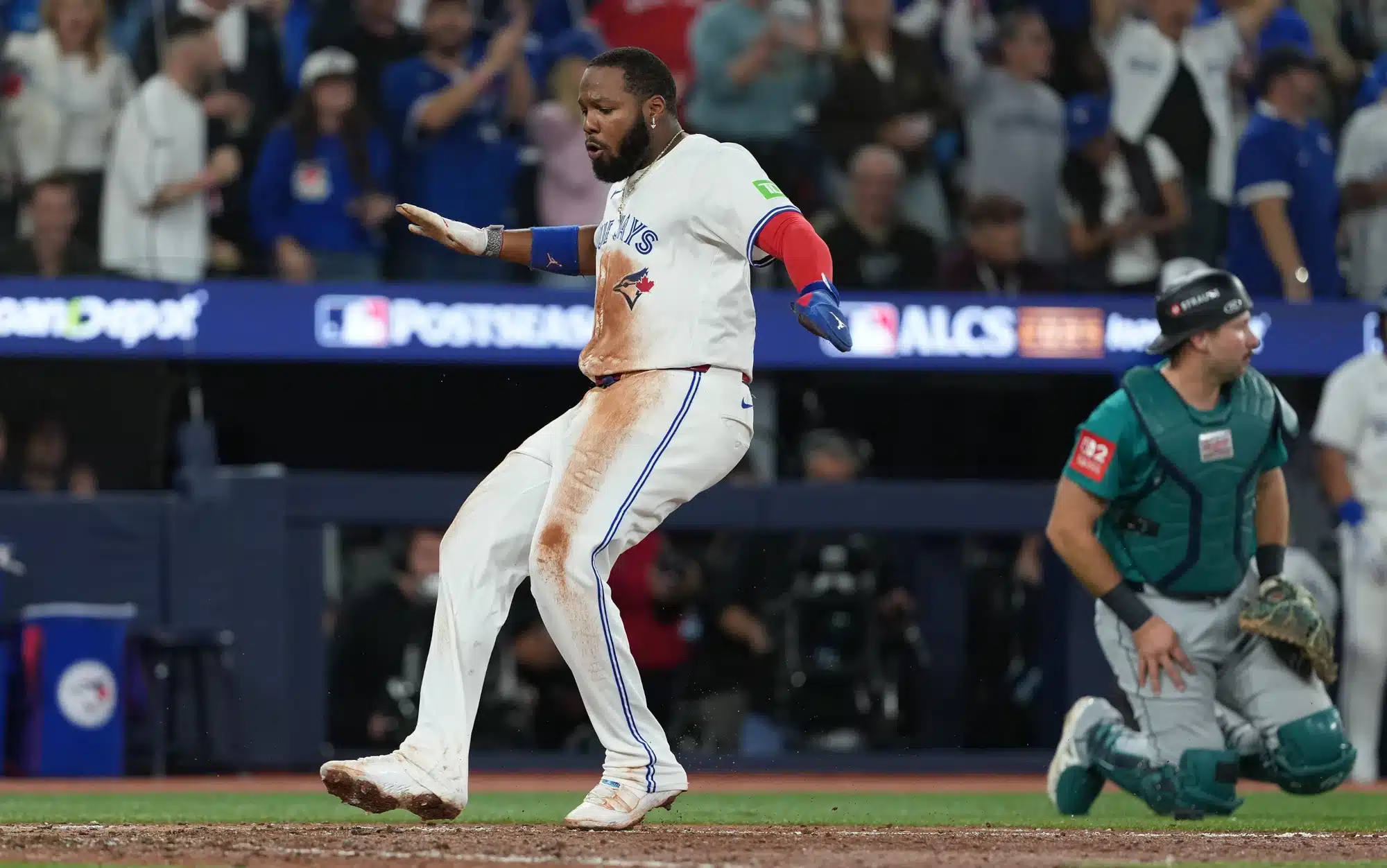 Oct 19, 2025; Toronto, Ontario, CAN; Toronto Blue Jays first baseman Vladimir Guerrero Jr. (27) celebrates after scoring in the seventh inning against the Seattle Mariners during game six of the ALCS round for the 2025 MLB playoffs at Rogers Centre.