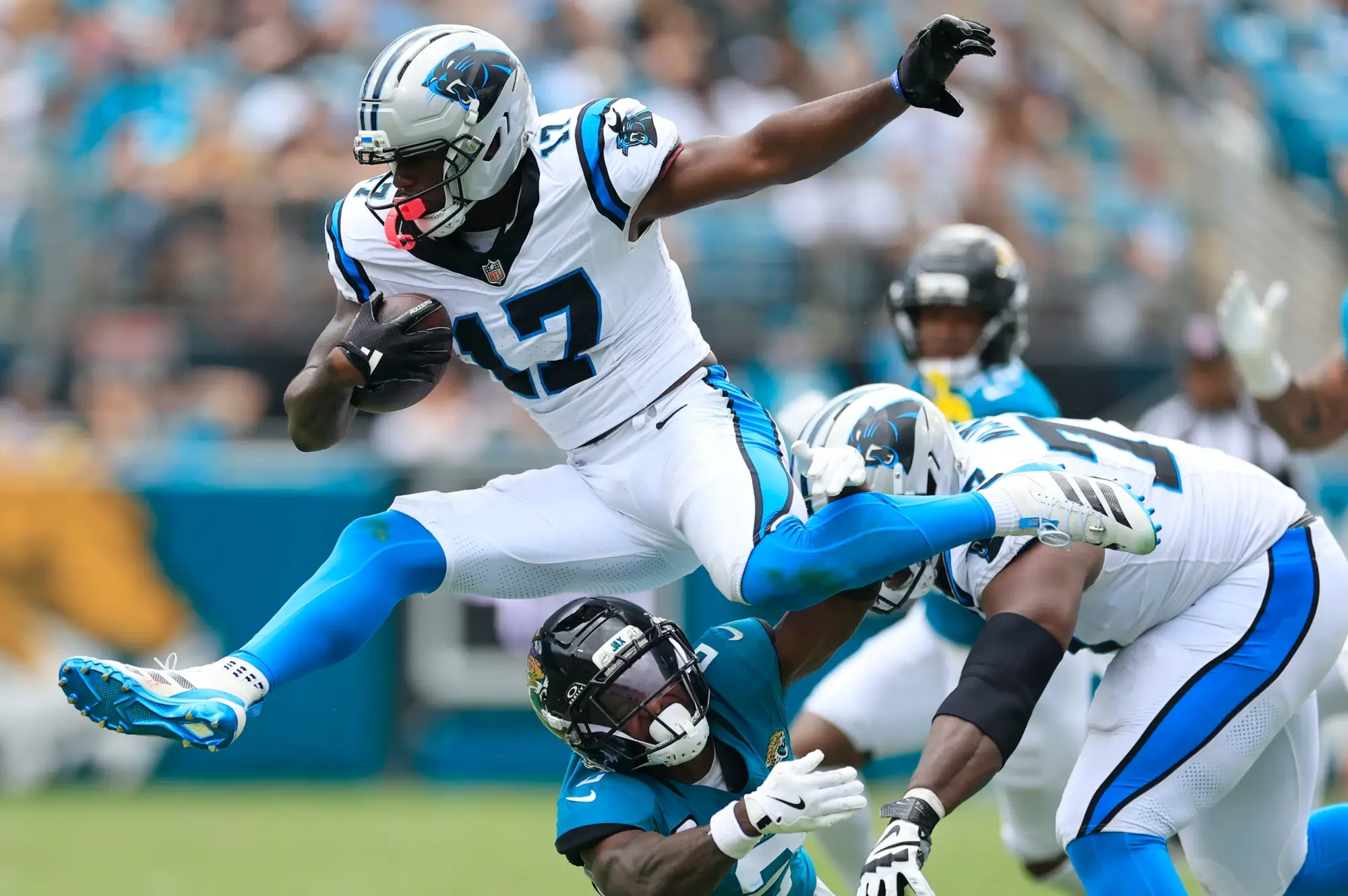 Carolina Panthers wide receiver Xavier Legette (17) leaps over Jacksonville Jaguars cornerback Jourdan Lewis (2) during the second quarter of an NFL football matchup at EverBank Stadium, Sunday, Sept. 7, 2025 in Jacksonville, Fla.
