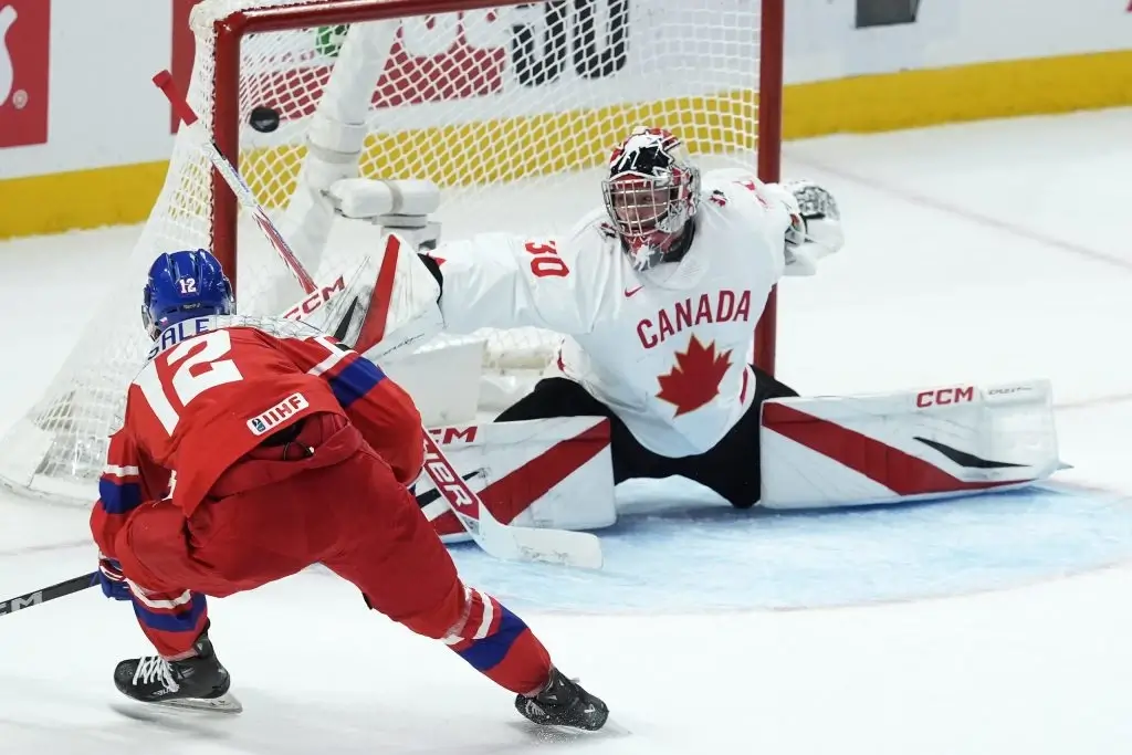 Czechia forward Eduard Sale (12) scores on Canada goalkeeper Carter George (30) during first period IIHF World Junior Hockey Championship quarterfinal action in Ottawa, Thursday, Jan. 2, 2025.