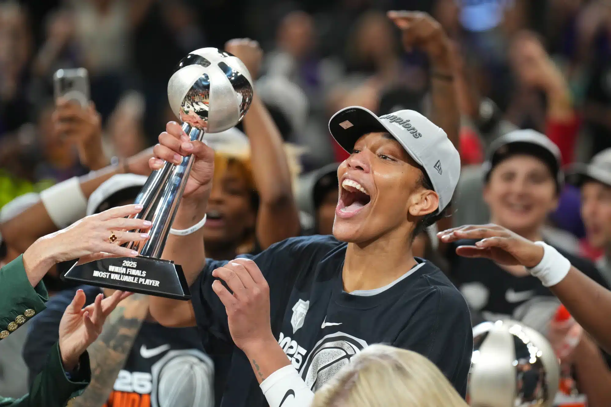 Oct 10, 2025; Phoenix, Arizona, USA; Las Vegas Aces center A'ja Wilson (22) celebrates with teammates after game four of the 2025 WNBA Finals at Mortgage Matchup Center.