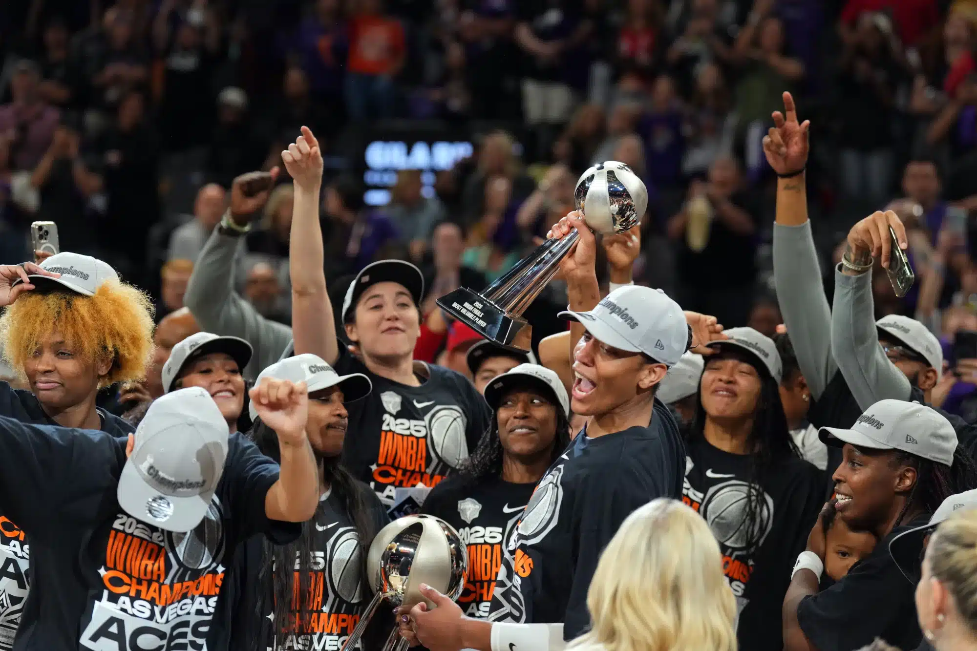 Oct 10, 2025; Phoenix, Arizona, USA; Las Vegas Aces center A'ja Wilson (22) celebrates with teammates after game four of the 2025 WNBA Finals at Mortgage Matchup Center.
