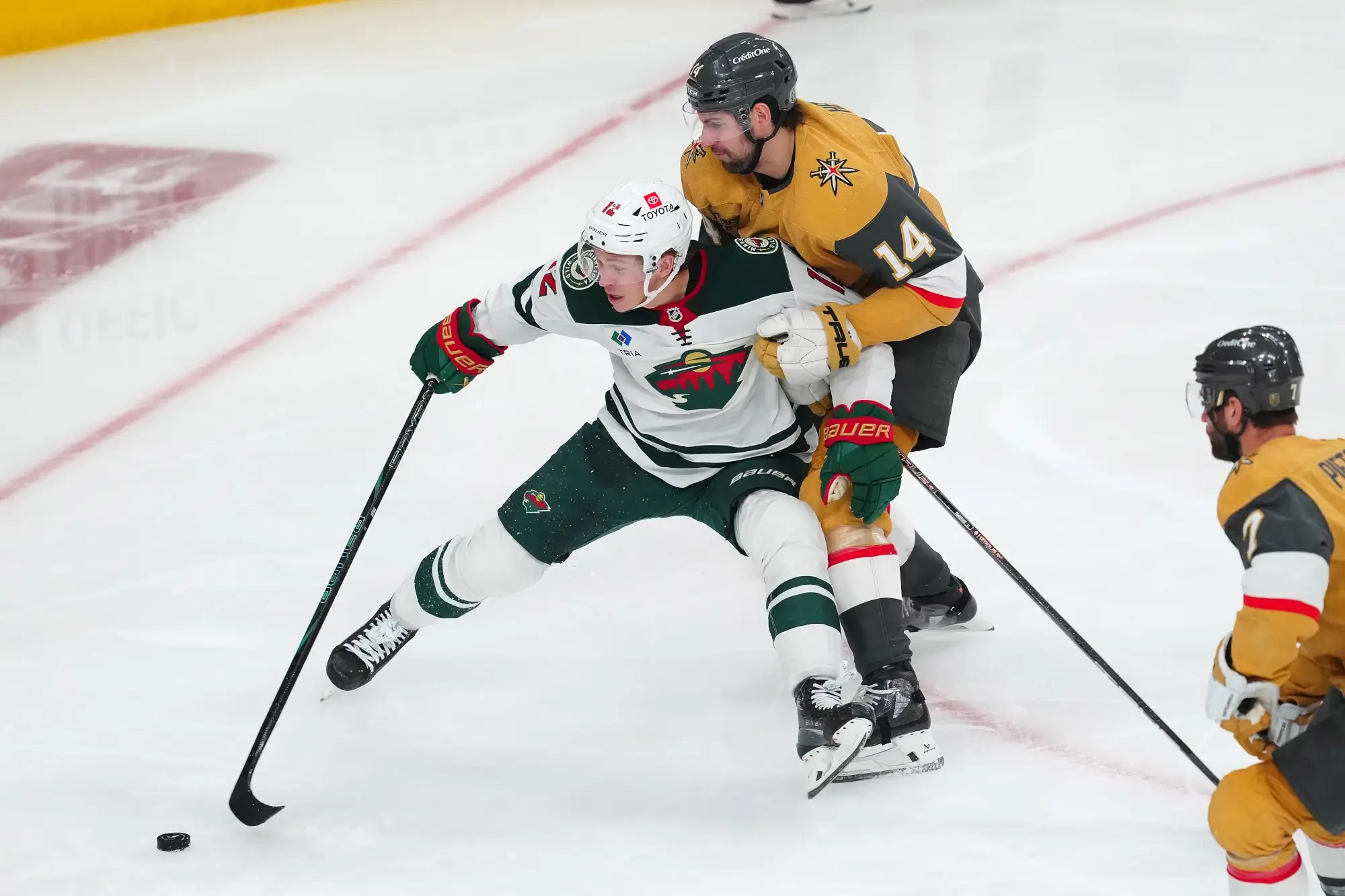 Apr 29, 2025; Las Vegas, Nevada, USA; Minnesota Wild left wing Matt Boldy (12) controls the puck ahead of Vegas Golden Knights defenseman Nicolas Hague (14) during the third period of game five of the first round of the 2025 Stanley Cup Playoffs at T-Mobile Arena.