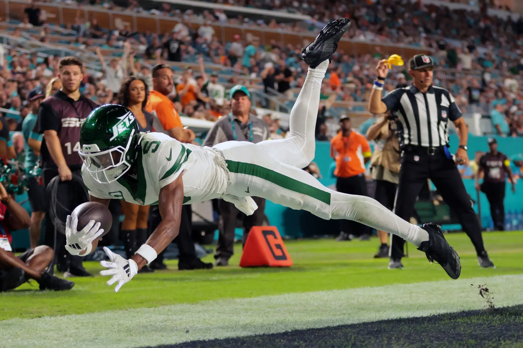 Sep 29, 2025; Miami Gardens, Florida, USA; New York Jets wide receiver Garrett Wilson (5) attempts to make a catch against Miami Dolphins cornerback Artie Burns (not pictured) during the second half at Hard Rock Stadium.