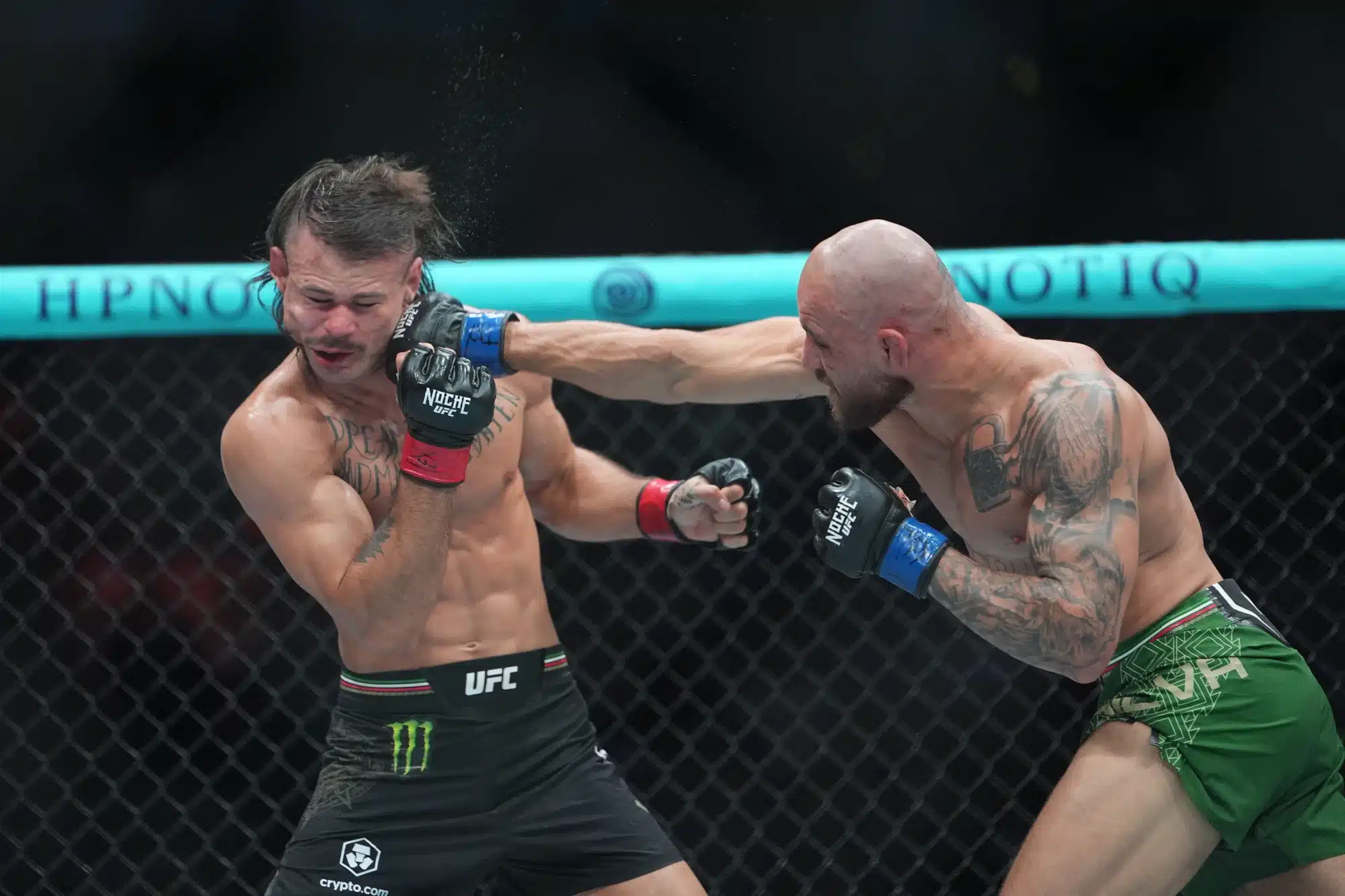Sep 13, 2025; San Antonio, Texas, UNITED STATES; Diego Lopes (red gloves) fights Jean Silva (blue gloves) during Noche UFC at Frost Bank Center.