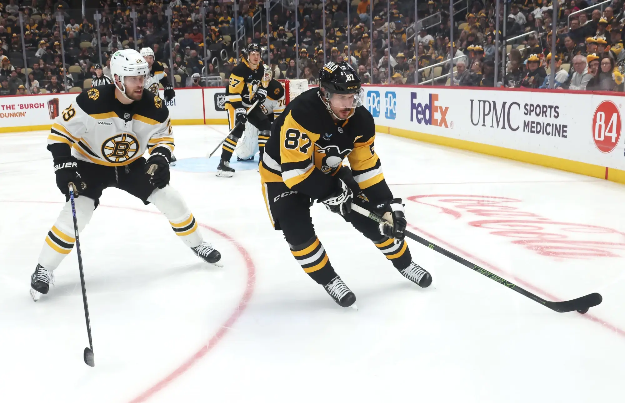 Apr 13, 2025; Pittsburgh, Pennsylvania, USA; Pittsburgh Penguins center Sidney Crosby (87) skates with the puck against Boston Bruins defenseman Parker Wotherspoon (29) during the third period at PPG Paints Arena.