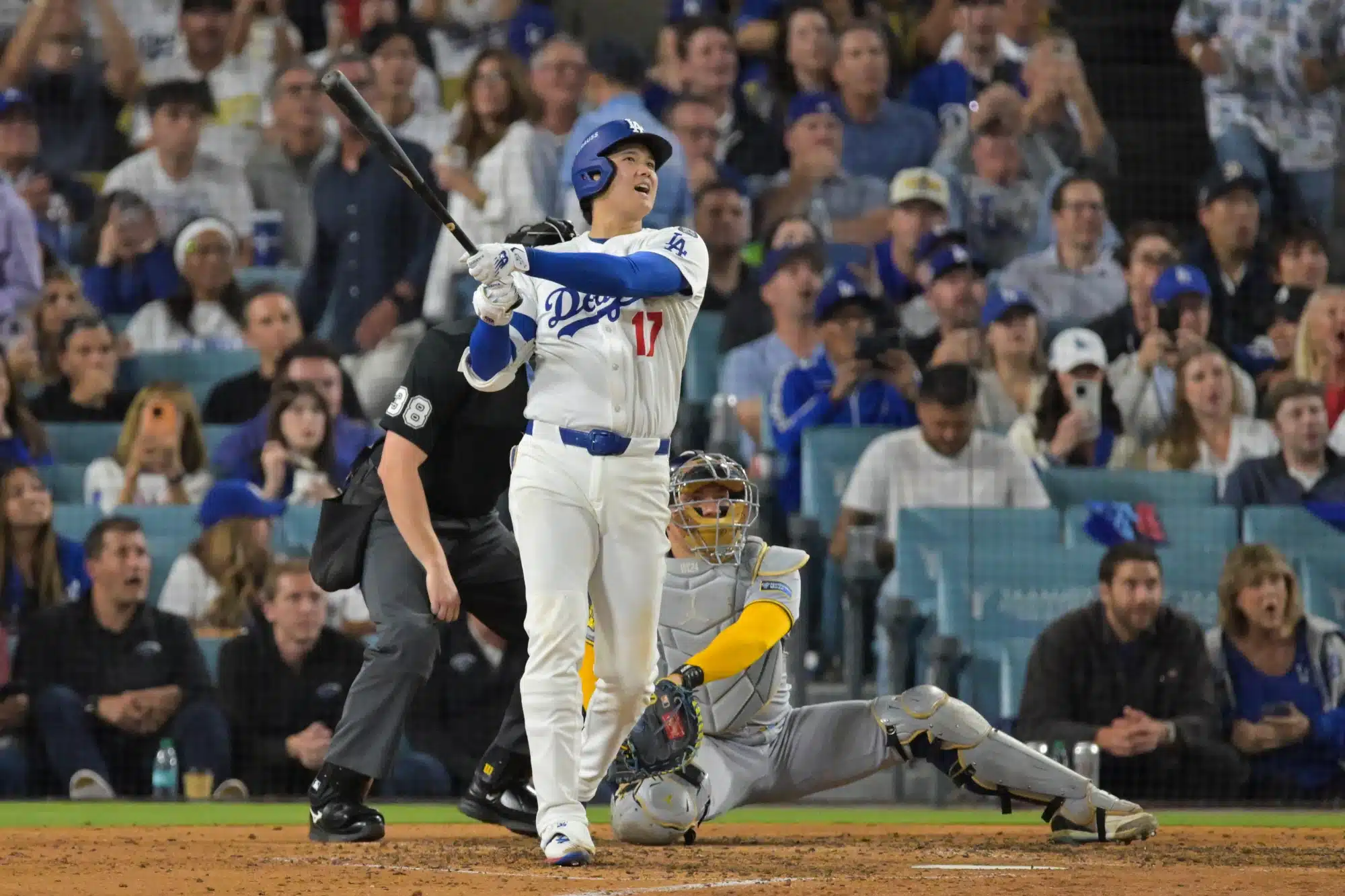 Oct 17, 2025; Los Angeles, California, USA; Los Angeles Dodgers two-way player Shohei Ohtani (17) hits a solo home run against the Milwaukee Brewers during the seventh inning of game four of the NLCS round for the 2025 MLB playoffs at Dodger Stadium.
