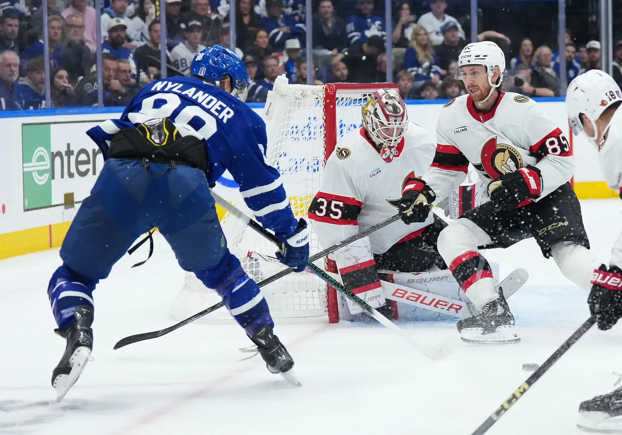 Apr 29, 2025; Toronto, Ontario, CAN; Toronto Maple Leafs right wing William Nylander (88) battles for the puck with Ottawa Senators defenseman Jake Sanderson (85) in the third period during game five of the first round of the 2025 Stanley Cup Playoffs at Scotiabank Arena.