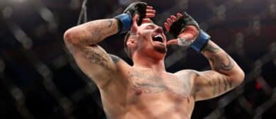 Tom Aspinall (blue gloves) reacts to beating Sergei Pavlovich (red gloves) during UFC 295 at Madison Square Garden.