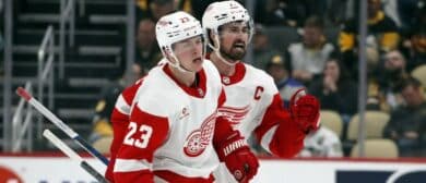 Detroit Red Wings left wing Lucas Raymond (23) and center Dylan Larkin (71) celebrate after Raymond scored a goal to complete a hat-trick against the Pittsburgh Penguins during the third period at PPG Paints Arena. Pittsburgh won 6-5 in overtime