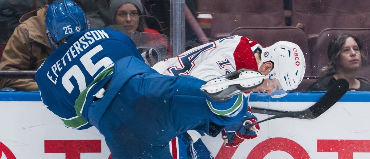 Vancouver Canucks defenseman Elias Pettersson (25) checks Montreal Canadiens forward Nick Suzuki (14) in the third period at Rogers Arena.