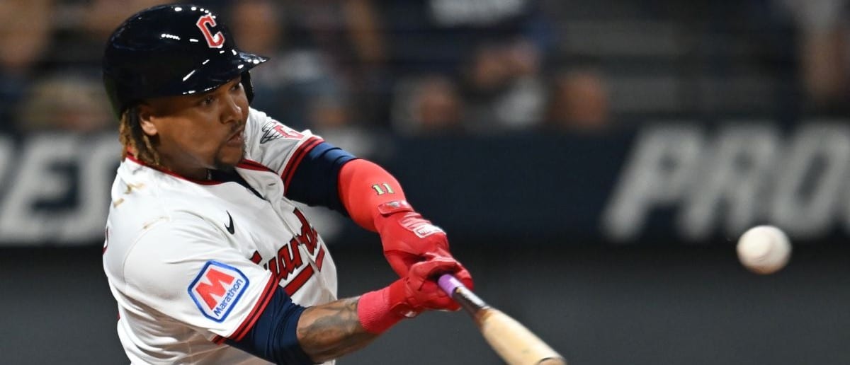 Cleveland Guardians third baseman Jose Ramirez (11) hits a single against the Texas Rangers during the first inning at Progressive Field.
