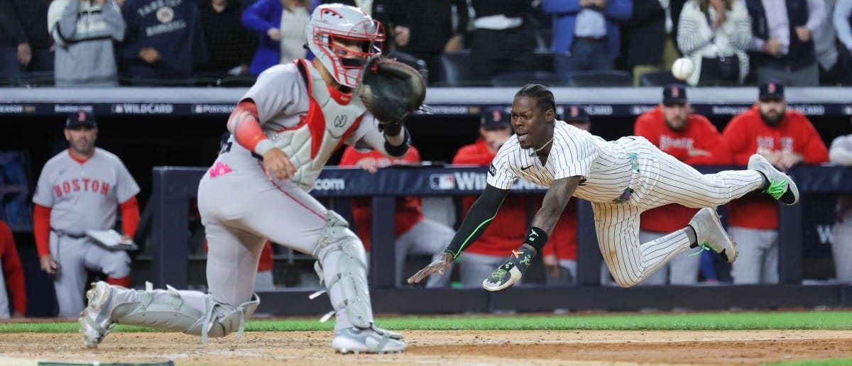 New York Yankees second baseman Jazz Chisholm Jr. (13) slides into home to score on an hits an RBI single from New York Yankees catcher Austin Wells (28) (not pictured) during the eighth inning against the Boston Red Sox during game two of the Wildcard round for the 2025 MLB playoffs at Yankee Stadium.