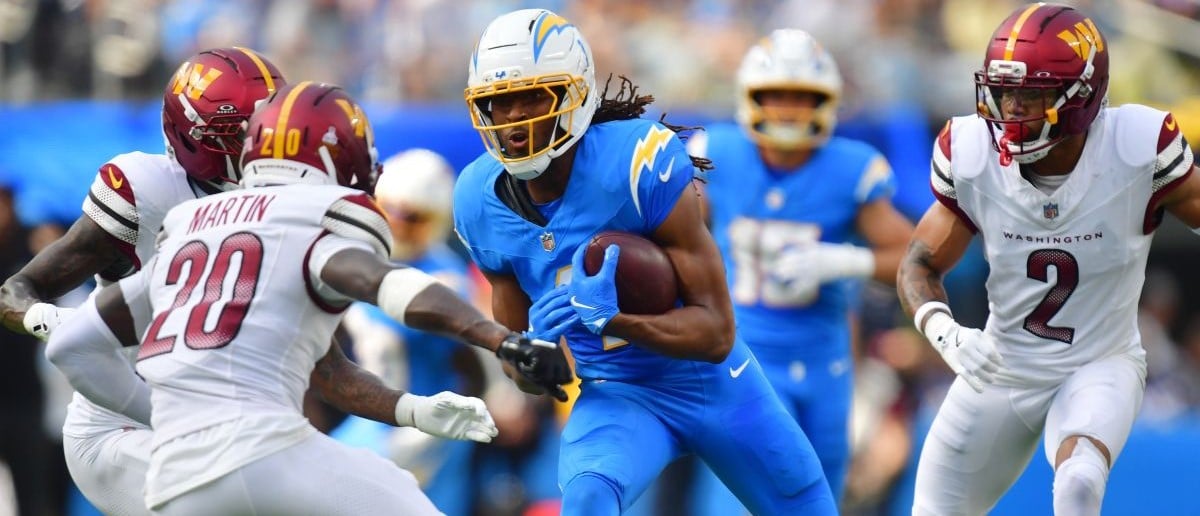 Los Angeles Chargers wide receiver Quentin Johnston (1) runs against Washington Commanders safety Quan Martin (20) in the first half at SoFi Stadium.