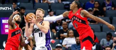 Sacramento Kings forward/center Domantas Sabonis (11) fights for a rebound against Toronto Raptors forward Brandon Ingram (3) and forward/guard RJ Barrett (9) during the third quarter at Golden 1 Center.