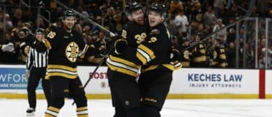 Boston Bruins center Morgan Geekie (39) is congratulated by defenseman Mason Lohrei (6) after scoring against the Colorado Avalanche during the second period at TD Garden