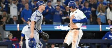 Toronto Blue Jays designated hitter George Springer (4) scores a run as Los Angeles Dodgers catcher Will Smith (16) looks on in the third inning during game two of the 2025 MLB World Series at Rogers Centre.
