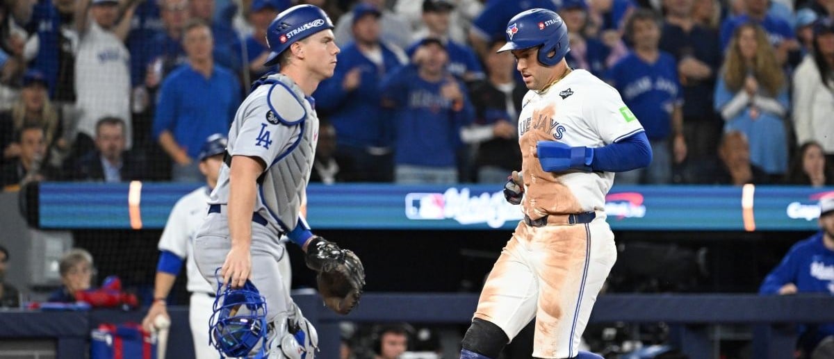 Toronto Blue Jays designated hitter George Springer (4) scores a run as Los Angeles Dodgers catcher Will Smith (16) looks on in the third inning during game two of the 2025 MLB World Series at Rogers Centre.
