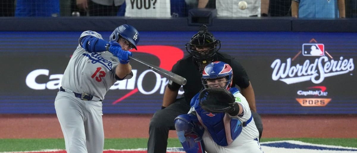 Los Angeles Dodgers third baseman Max Muncy (13) hits a solo home run against the Toronto Blue Jays in the seventh inning during game two of the 2025 MLB World Series at Rogers Centre