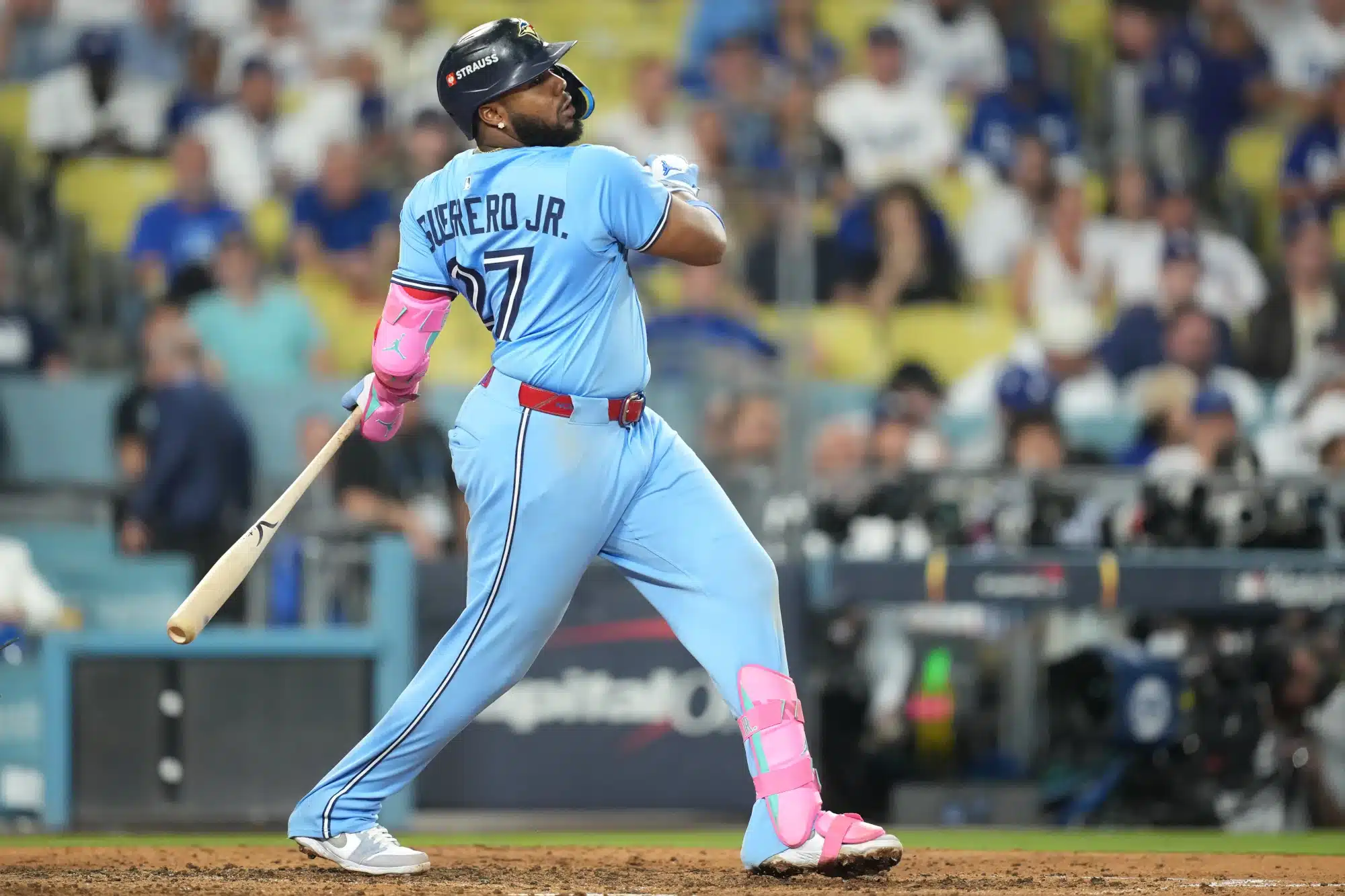 Oct 28, 2025; Los Angeles, California, USA; Toronto Blue Jays first baseman Vladimir Guerrero Jr. (27) hits a single against the Los Angeles Dodgers in the ninth inning during game four of the 2025 MLB World Series at Dodger Stadium.