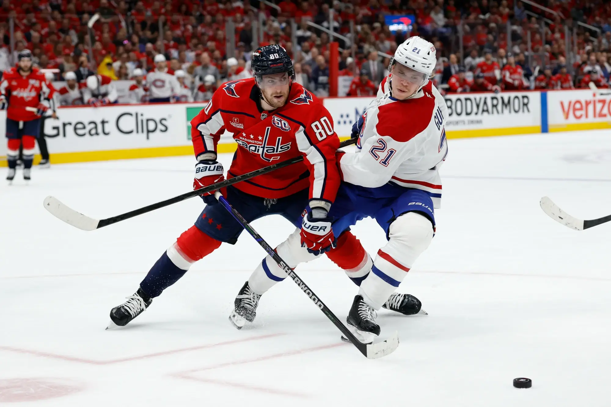 Apr 30, 2025; Washington, District of Columbia, USA; Washington Capitals left wing Pierre-Luc Dubois (80) battles for the puck with Montreal Canadiens defenseman Kaiden Guhle (21) in game five of the first round of the 2025 Stanley Cup Playoffs at Capital One Arena.