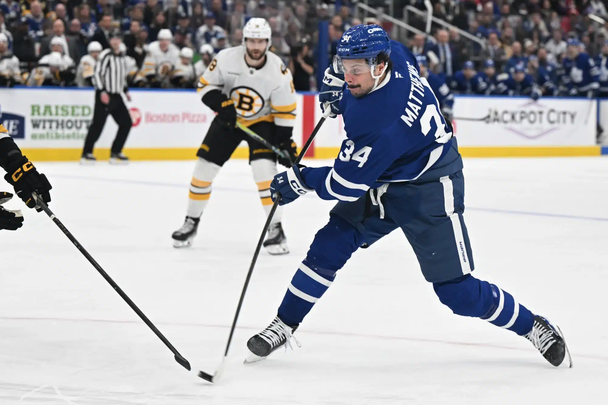 Nov 8, 2025; Toronto, Ontario, CAN; Toronto Maple Leafs forward Auston Matthews (34) shoots the puck against the Boston Bruins in the third period at Scotiabank Arena.