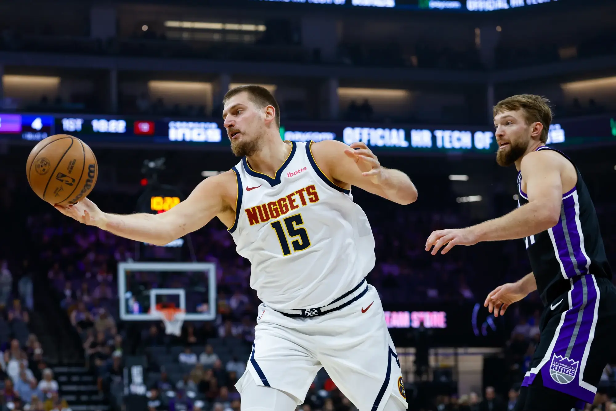 Nov 11, 2025; Sacramento, California, USA; Denver Nuggets center Nikola Jokic (15) reaches for the ball against Sacramento Kings center Domantas Sabonis (11) during the first quarter at Golden 1 Center. 
