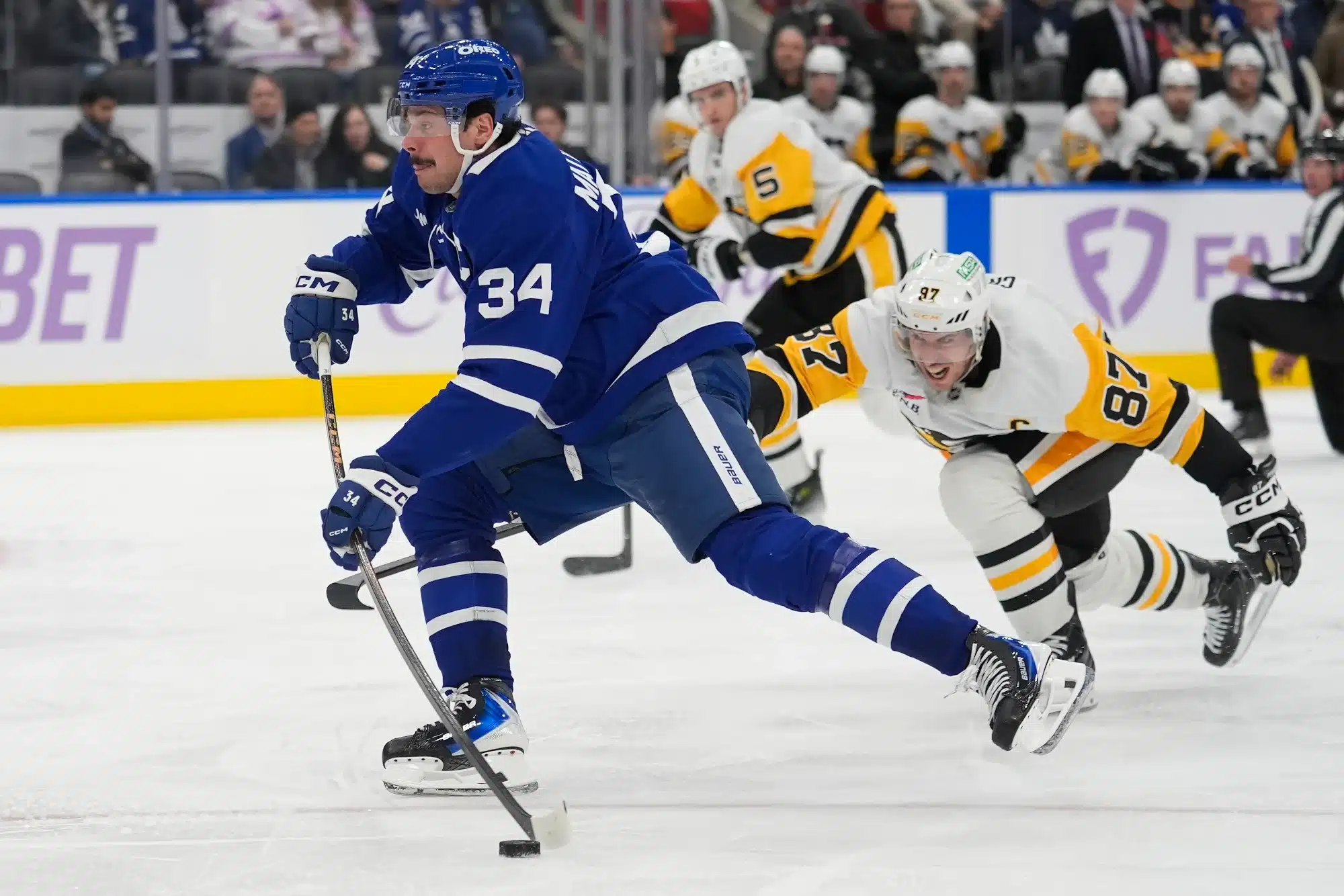 Nov 3, 2025; Toronto, Ontario, CAN; Toronto Maple Leafs forward Auston Matthews (34) scores against Pittsburgh Penguins forward Sidney Crosby (87) during the third period at Scotiabank Arena.