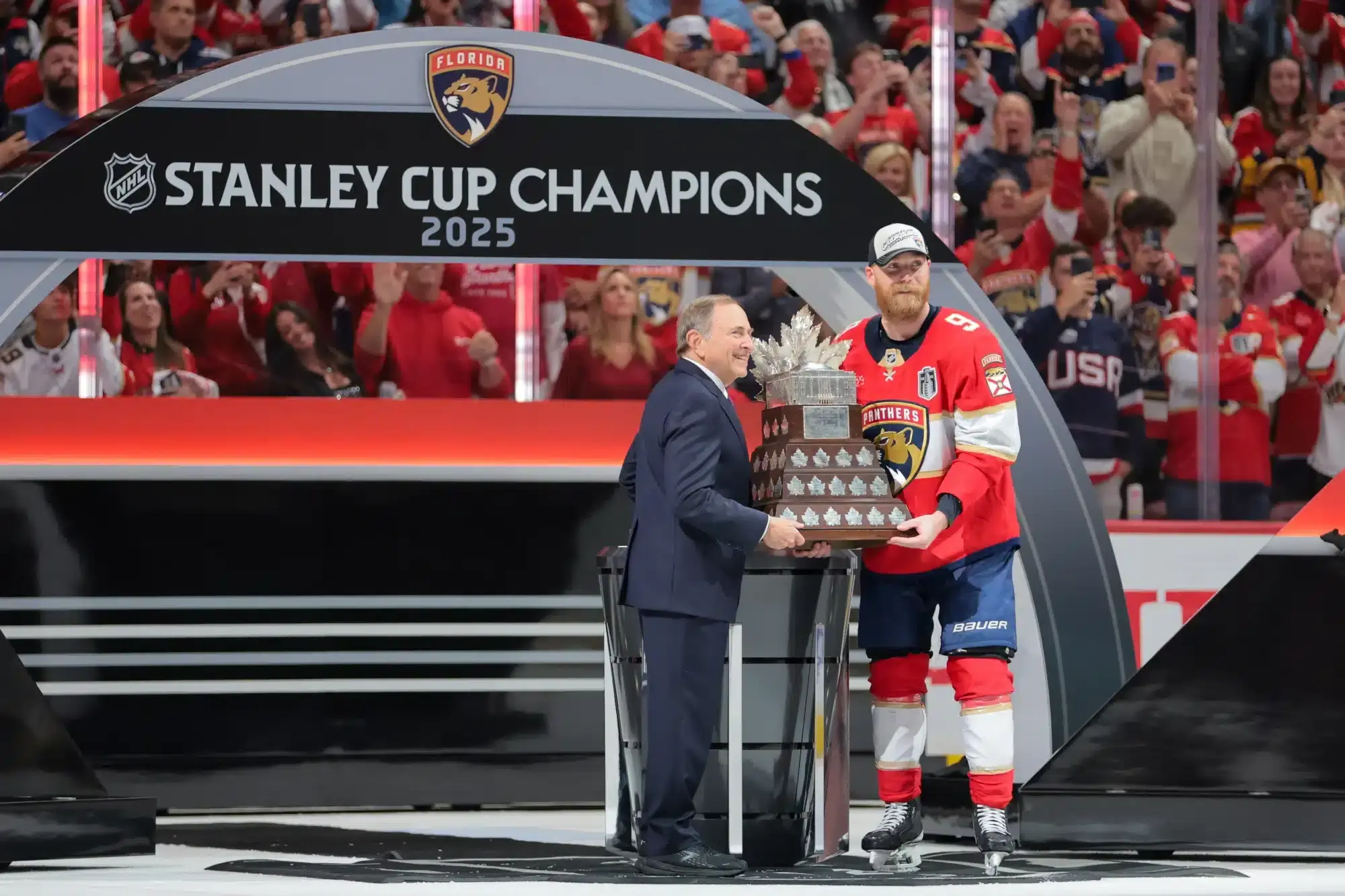 Jun 17, 2025; Sunrise, Florida, USA; Gary Bettman, NHL Commissioner, presents Florida Panthers center Sam Bennett (9) the Conn Smythe Trophy after winning game six of the 2025 Stanley Cup Final against the Edmonton Oilers at Amerant Bank Arena.