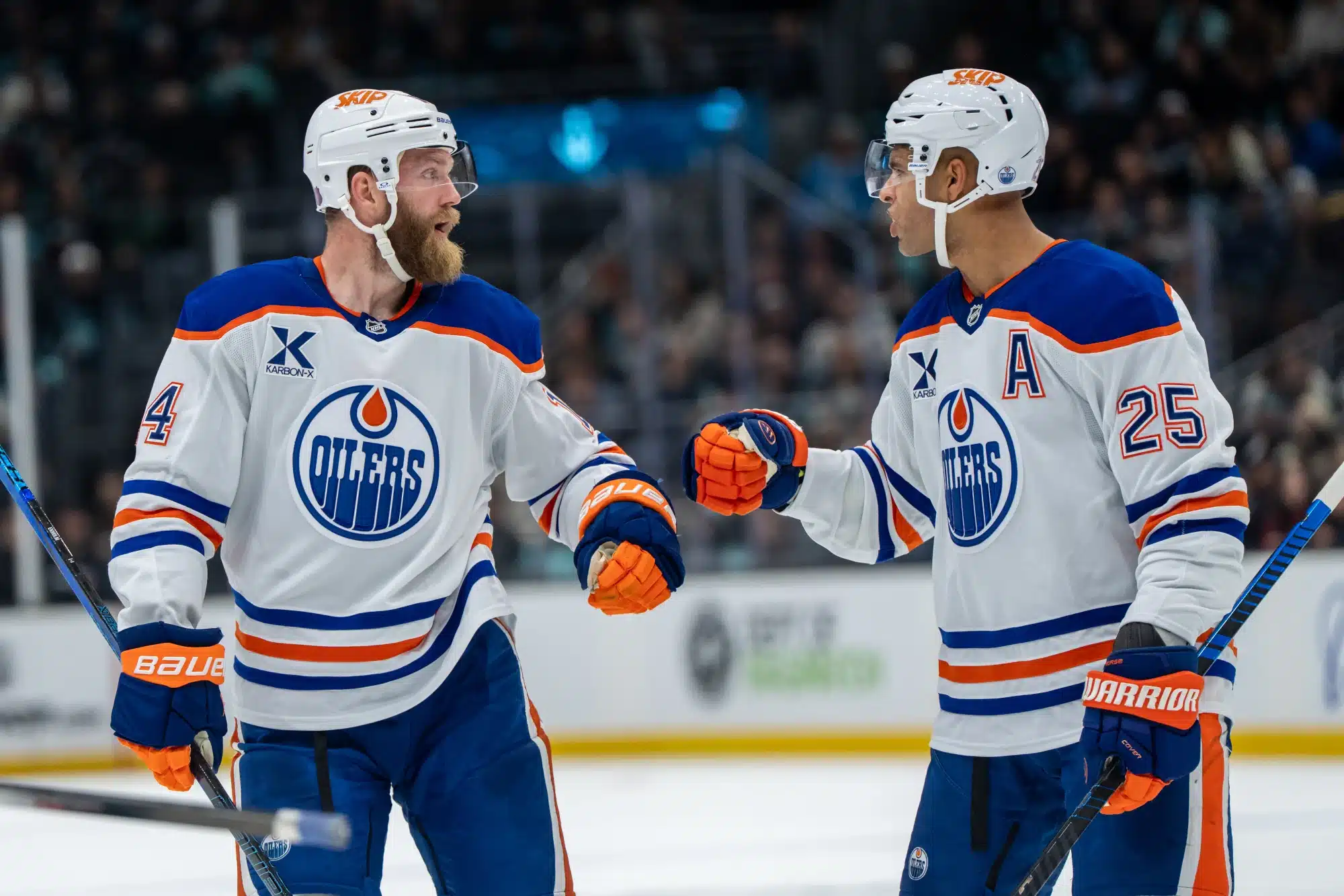 Oct 25, 2025; Seattle, Washington, USA; Edmonton Oilers defenseman Mattias Ekholm (14) and defenseman Darnell Nurse (25) celebrate after a goal during the third period against the Seattle Kraken at Climate Pledge Arena.