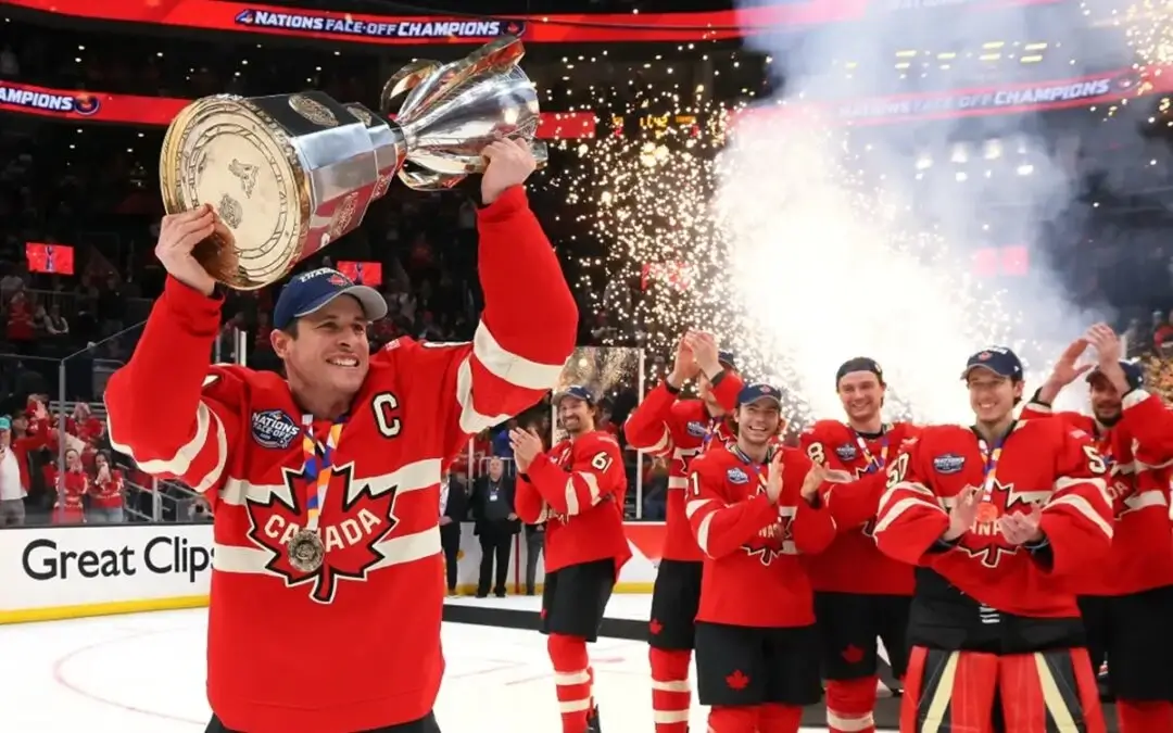 Sidney Crosby rasies the Four Nations Face Off trophy with Team Canada celebrating on the ice behind him on February 20, 2025.