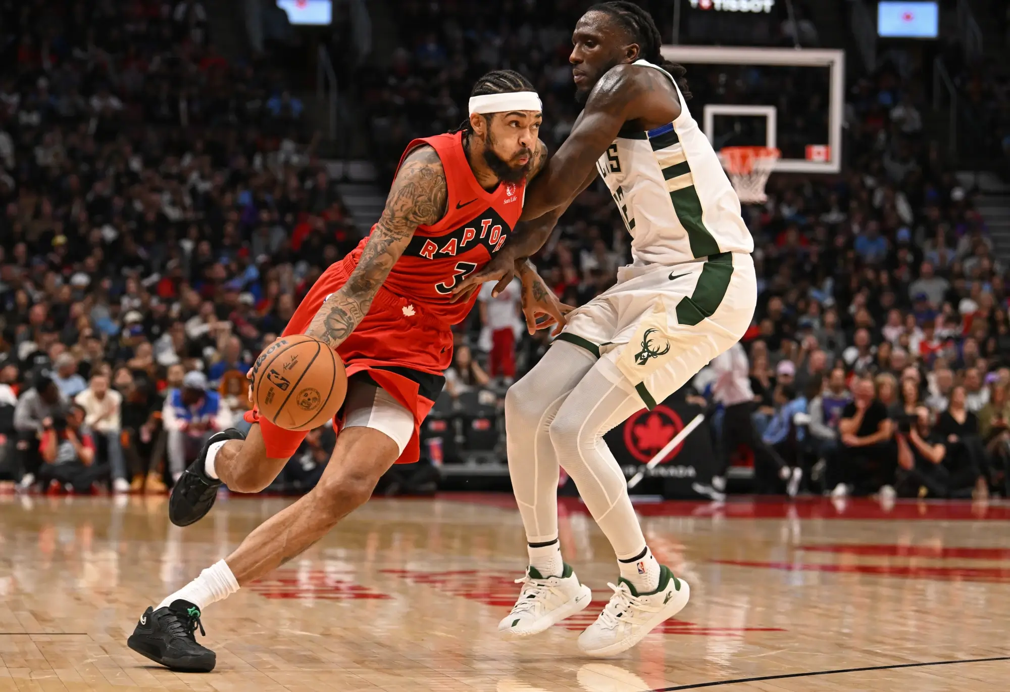 Oct 24, 2025; Toronto, Ontario, CAN; Toronto Raptors forward Brandon Ingram (3) dribbles past Milwaukee Bucks forward Taurean Prince (12) in the fourth quarter at Scotiabank Arena.